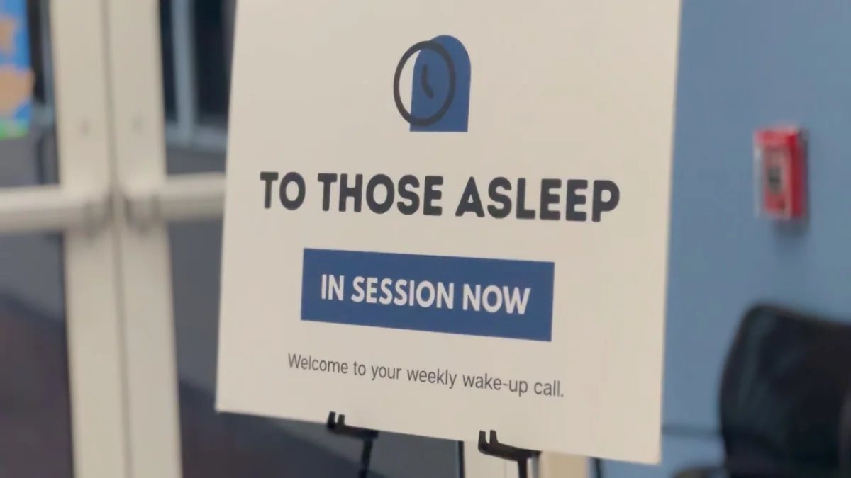 A sign at the door reading in session now.